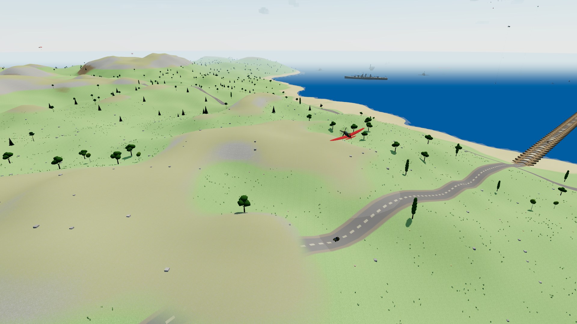 A crimson fighter banking low over rolling green hills dotted with oaks and pines, a paved road winding across them to a sandy beach, a timber bridge running out over the sea to a battleship at anchor